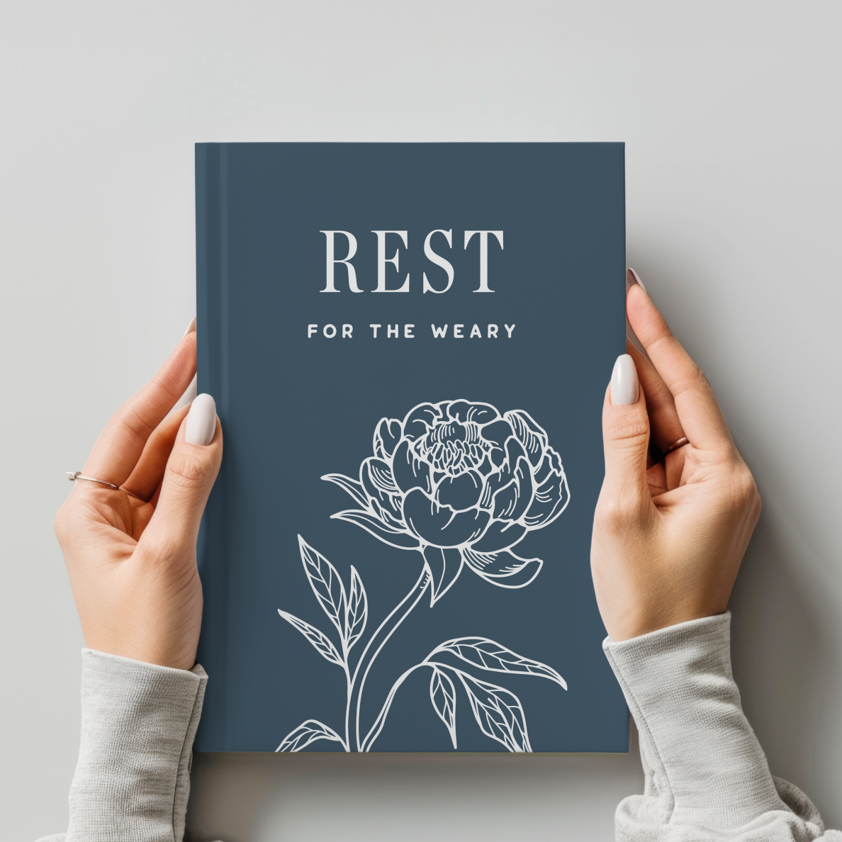 Book titled 'Rest for the Weary' with a floral design on a gray background