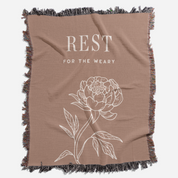 Brown blanket with floral design and text 'REST FOR THE WEARY' on a white background