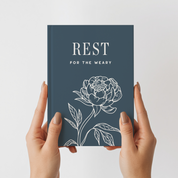 Book titled 'Rest for the Weary' with a floral design on a white background