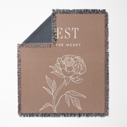 Blanket with floral design and text on a beige background