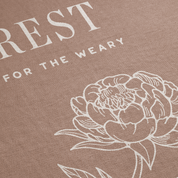 Brown fabric with white floral design and text 'REST FOR THE WEARY'.