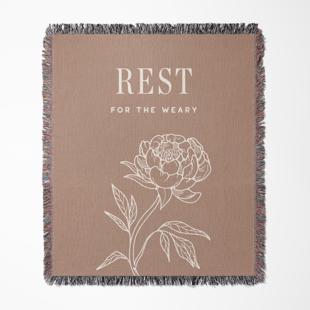 Blanket with floral design and text 'REST FOR THE WEARY' on a beige background