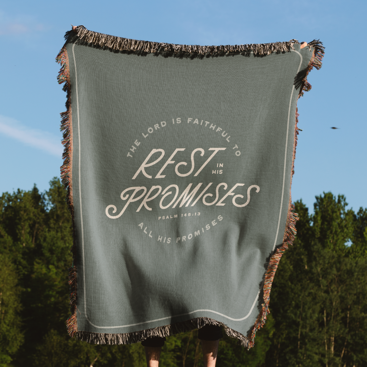 Green blanket with text 'The Lord is faithful to rest in His promises' against a natural background
