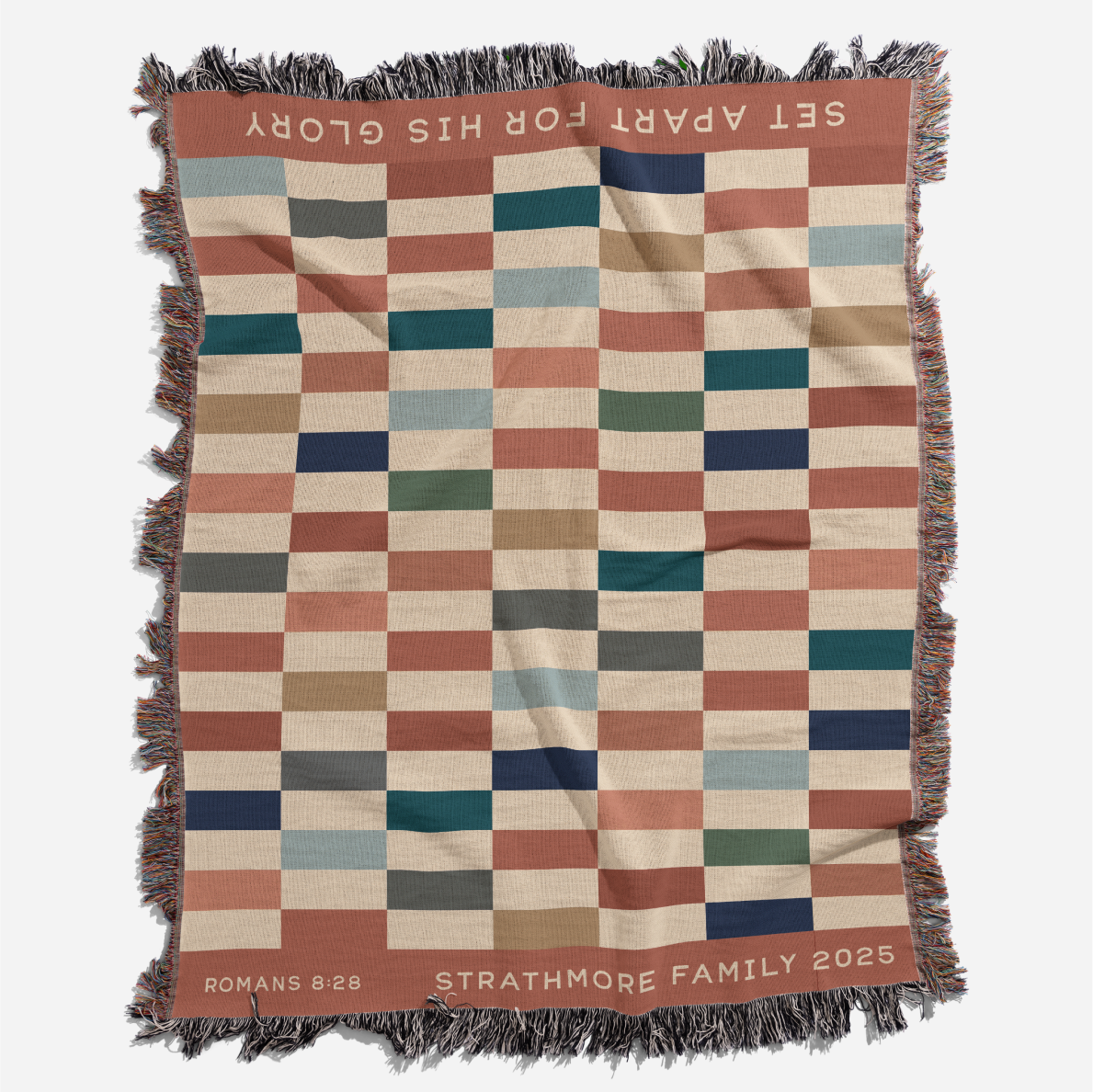 Checkered blanket with text and branding on a white background