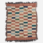 Checkered blanket with text and branding on a white background
