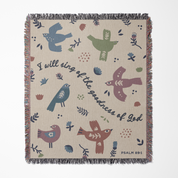 Decorative blanket with bird illustrations and text on a beige background