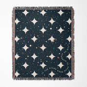 Patterned throw blanket with star design and text on a plain background