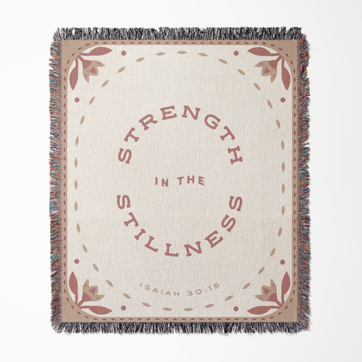 Blanket with 'Strength in the Stillness' text and floral patterns on a beige background
