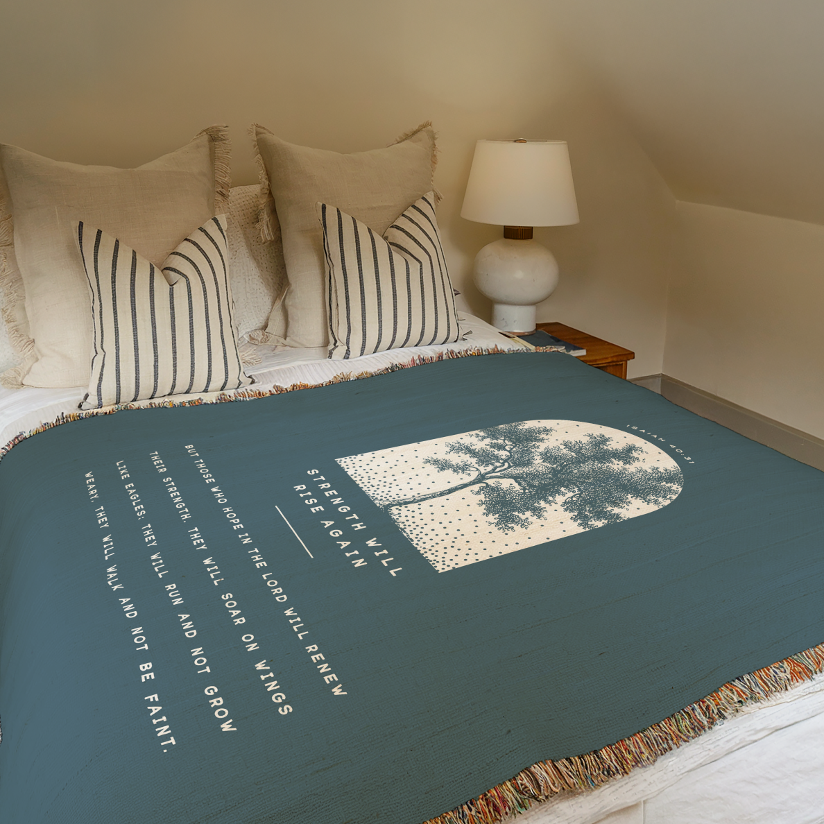 Bed with green blanket featuring a tree design and text, in a bedroom setting.