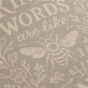 Neutral-toned woven blanket with the phrase “Kind words are like honey,” floral accents, and a honey bee; made of 100% cotton with fringe, perfect Christian gift.