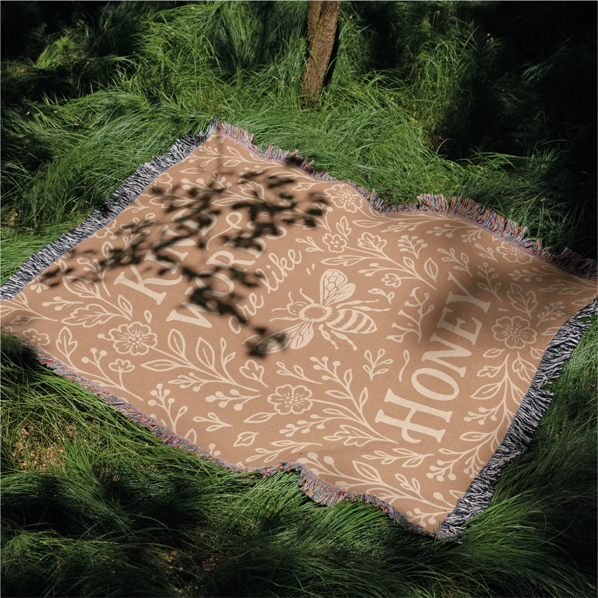 Warm-toned woven blanket with the phrase “Kind words are like honey,” floral accents, and a honey bee; 100% cotton with fringe, perfect for Christian gifting and home decor.
