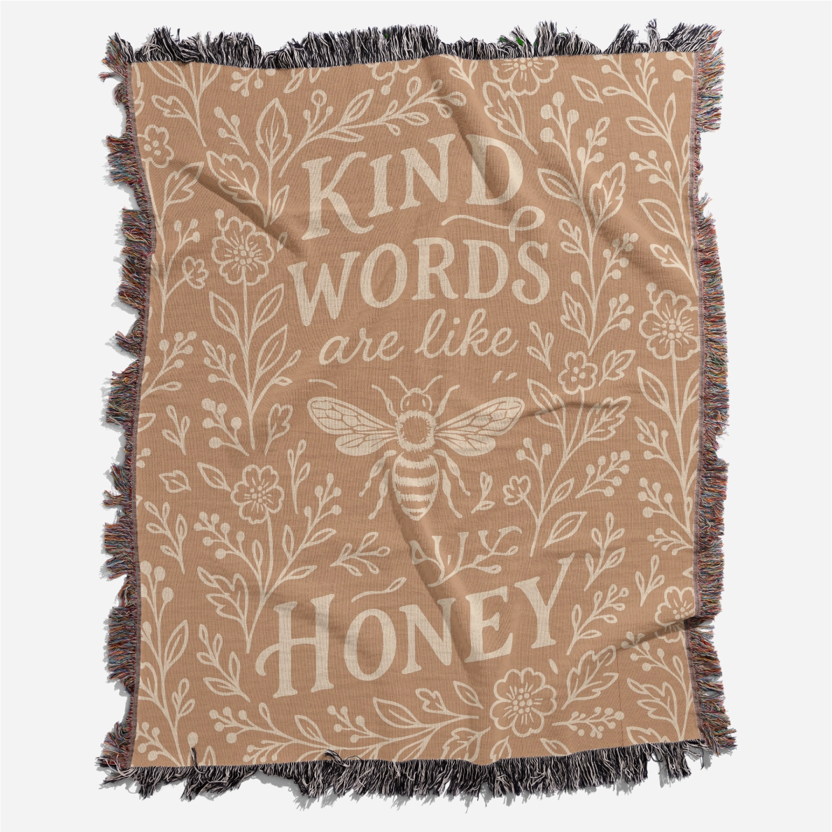 Warm-toned woven blanket with the phrase “Kind words are like honey,” floral accents, and a honey bee; 100% cotton with fringe, perfect for Christian gifting and home decor.