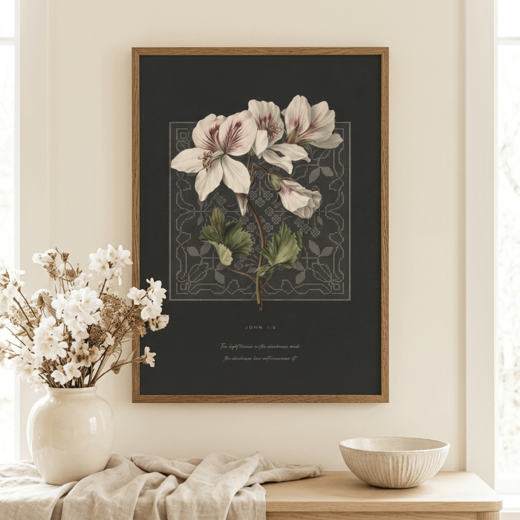 John 1:5 wall art framed above a table with fresh white flowers — christian bible verse decor in a styled room
