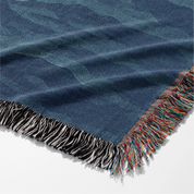 Woven Christian blanket depicting Jesus walking on water, made of 100% cotton with colorful fringe; perfect for home decor, prayer spaces, or faith-based gifts.
