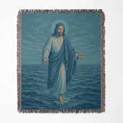 Woven Christian blanket depicting Jesus walking on water, made of 100% cotton with colorful fringe; perfect for home decor, prayer spaces, or faith-based gifts.