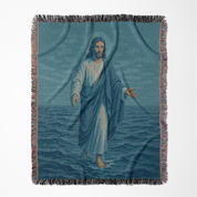 Woven Christian blanket depicting Jesus walking on water, made of 100% cotton with colorful fringe; perfect for home decor, prayer spaces, or faith-based gifts.