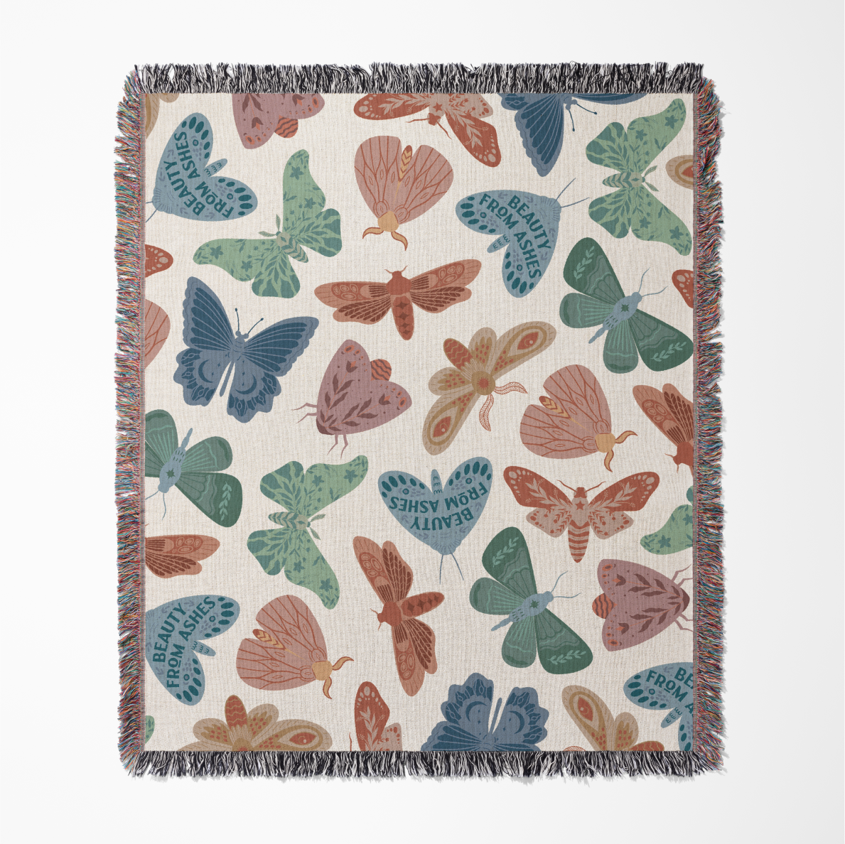 Faith-inspired woven blanket with hand-drawn butterflies and moths on a soft light background, made from 100% cotton with colorful fringed edges—Christian home decor.