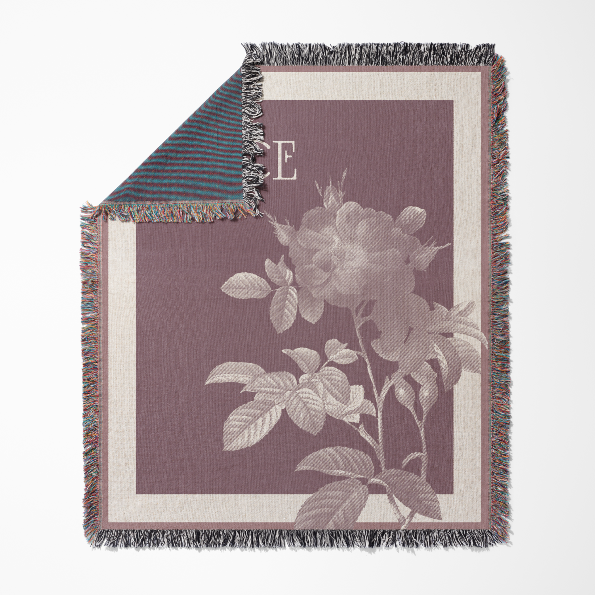 Floral patterned throw blanket with a rose design on a white background