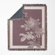 Floral patterned throw blanket with a rose design on a white background